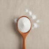 Gypsum Powder (Calcium Sulfate Dihydrate) (CaSO₄·2H₂O) | Create a luxurious, photorealistic product photograph featuring the original product naturally arranged in an elegant handcrafted wooden spoon on a soft, finely