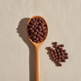 Hawthorn Berries Whole (Crataegus Laevigata) | Create a luxurious, photorealistic product photograph featuring the original product naturally arranged in an elegant handcrafted wooden spoon on a soft, finely