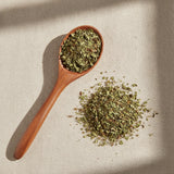 Hawthorn Leaf & Flowers Cut (Crataegus Laevigata) | Create a luxurious, photorealistic product photograph featuring the original product naturally arranged in an elegant handcrafted wooden spoon on a soft, finely
