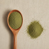 Horny Goat Weed Powder (Epimedium Sagittatum) | Create a luxurious, photorealistic product photograph featuring the original product naturally arranged in an elegant handcrafted wooden spoon on a soft, finely