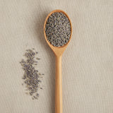 Lavender Flowers Whole (Lavandula Angustifolia) | Create a luxurious, photorealistic product photograph featuring the original product naturally arranged in an elegant handcrafted wooden spoon on a soft, finely