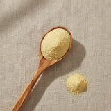 Lecithin Soy Powder (Phosphatidyl Choline) | Create a luxurious, photorealistic product photograph featuring the original product naturally arranged in an elegant handcrafted wooden spoon on a soft, finely
