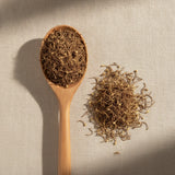 Lotus Stamen Whole (Nelumbo Nucifera) | Create a luxurious, photorealistic product photograph featuring the original product naturally arranged in an elegant handcrafted wooden spoon on a soft, finely