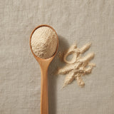 Marshmallow Root Powder (Althaea Officinalis) | Create a luxurious, photorealistic product photograph featuring the original product naturally arranged in an elegant handcrafted wooden spoon on a soft, finely