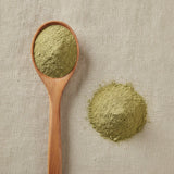 Mexican Honeysuckle Herb Powder (Justicia Spicigera) | Create a luxurious, photorealistic product photograph featuring the original product naturally arranged in an elegant handcrafted wooden spoon on a soft, finely