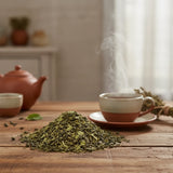 Moroccan Mint Green Tea (Camellia Sinensis) | Can you show this tea outside of the bag and bowl, on a table next to a hot tea cup in a rustic home.