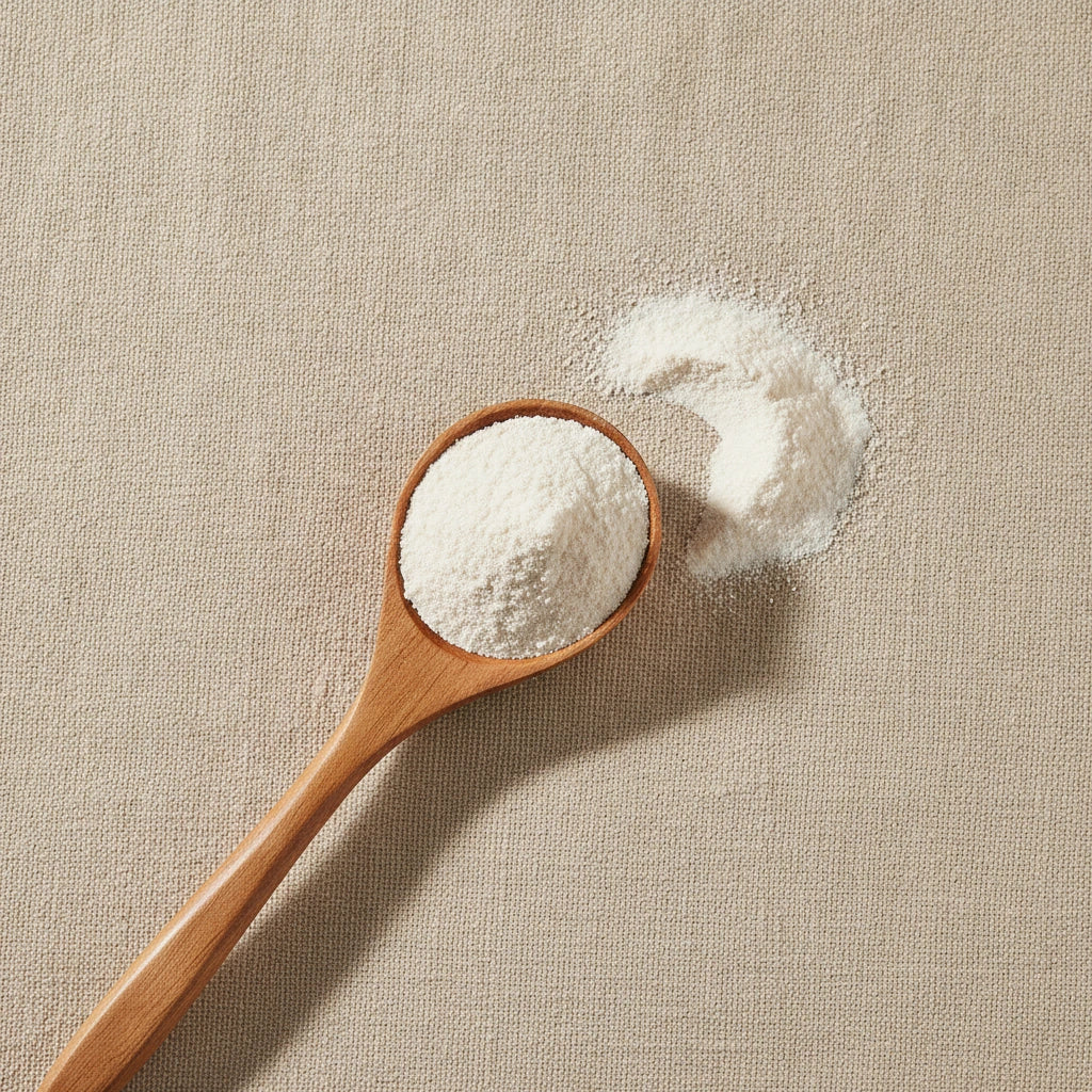 Mother-of-Pearl Shell Powder (Pteria Martensii) | Create a luxurious, photorealistic product photograph featuring the original product naturally arranged in an elegant handcrafted wooden spoon on a soft, finely