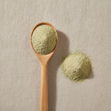 Oatstraw Powder (Avena Sativa) | Create a luxurious, photorealistic product photograph featuring the original product naturally arranged in an elegant handcrafted wooden spoon on a soft, finely