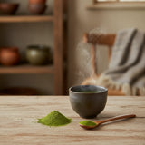 Organic Japanese Matcha, Culinary Grade (Camellia Sinensis) | Can you show this tea outside of the bag and bowl, on a table next to a hot tea cup in a rustic home.