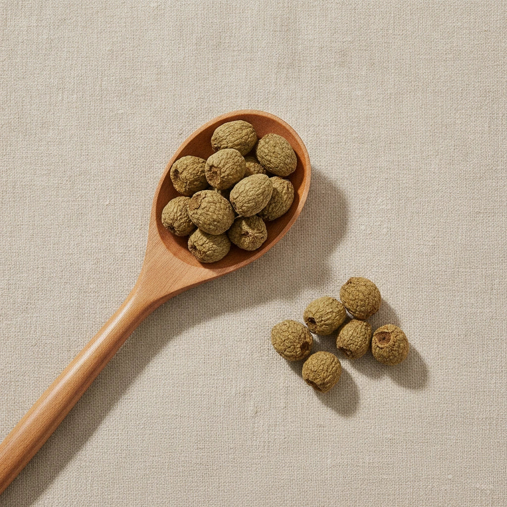 Palm Leaf Raspberry Fruit Whole (Rubus Chingii) | Create a luxurious, photorealistic product photograph featuring the original product naturally arranged in an elegant handcrafted wooden spoon on a soft, finely