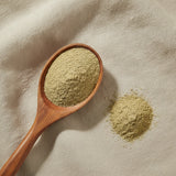 Palo Guaco Herb Powder (Mikania Glomerata) | Create a luxurious, photorealistic product photograph featuring the original product naturally arranged in an elegant handcrafted wooden spoon on a soft, finely