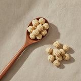 Panax Ginseng Flowers Whole (Panax Notoginseng) | Create a luxurious, photorealistic product photograph featuring the original product naturally arranged in an elegant handcrafted wooden spoon on a soft, finely