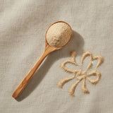 Panax Ginseng Powder (Panax Notoginseng) | Create a luxurious, photorealistic product photograph featuring the original product naturally arranged in an elegant handcrafted wooden spoon on a soft, finely