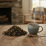 Passion Fruit Black Tea (Camellia Sinensis) | Can you show this tea outside of the bag and bowl, on a table next to a hot tea cup in a rustic home.
