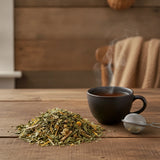 Peaceful Prana Herbal Tea | Can you show this tea outside of the bag and bowl, on a table next to a hot tea cup in a rustic home.