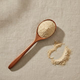 Prickly Pear Cactus Powder (Opuntia Ficus-indica) | Create a luxurious, photorealistic product photograph featuring the original product naturally arranged in an elegant handcrafted wooden spoon on a soft, finely