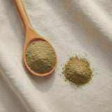 Red Clover Herb Powder (Trifolium Pratense) | Create a luxurious, photorealistic product photograph featuring the original product naturally arranged in an elegant handcrafted wooden spoon on a soft, finely