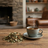 Relax Herbal Tea | Can you show this tea outside of the bag and bowl, on a table next to a hot tea cup in a rustic home.