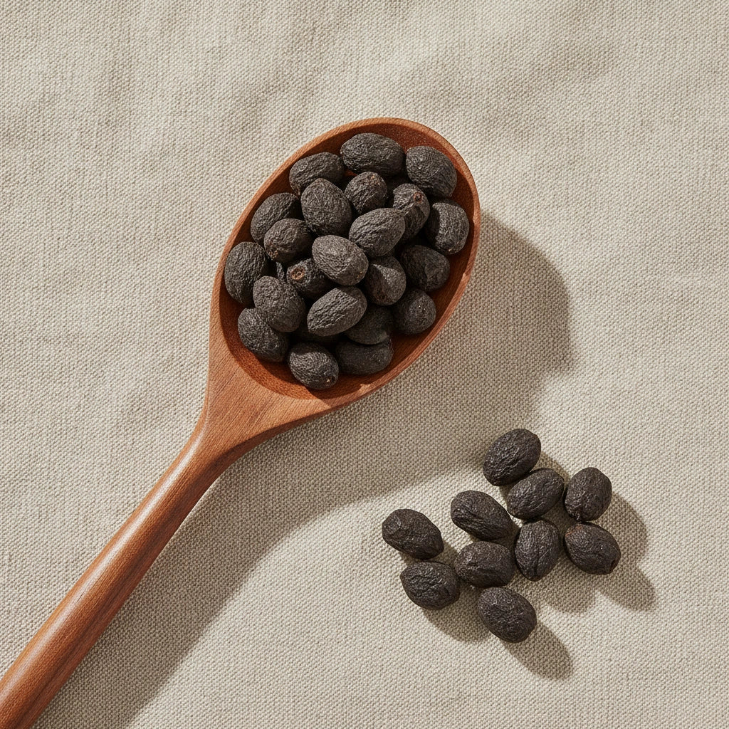 Saw Palmetto Berry Whole (Serenoa Repens) | Create a luxurious, photorealistic product photograph featuring the original product naturally arranged in an elegant handcrafted wooden spoon on a soft, finely