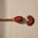 Schisandra Berry Powder (Schisandra Chinensis) | Create a luxurious, photorealistic product photograph featuring the original product naturally arranged in an elegant handcrafted wooden spoon on a soft, finely