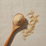 Silkvine Root Bark Powder (Periploca Sepium Bunge) | Create a luxurious, photorealistic product photograph featuring the original product naturally arranged in an elegant handcrafted wooden spoon on a soft, finely