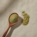 Skullcap Herb Powder (Scutellaria Lateriflora) | Create a luxurious, photorealistic product photograph featuring the original product naturally arranged in an elegant handcrafted wooden spoon on a soft, finely