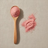 Strawberry Freeze-Dried Powder (Fragaria Virginiana) | Create a luxurious, photorealistic product photograph featuring the original product naturally arranged in an elegant handcrafted wooden spoon on a soft, finely