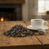 Tropicana Black Tea (Camellia Sinensis) | Can you show this tea outside of the bag and bowl, on a table next to a hot tea cup in a rustic home.