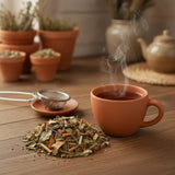 Tummy Herbal Tea | Can you show this tea outside of the bag and bowl, on a table next to a hot tea cup in a rustic home.