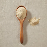 Wereke Root Powder (Ibervillea Sonorae) | Create a luxurious, photorealistic product photograph featuring the original product naturally arranged in an elegant handcrafted wooden spoon on a soft, finely