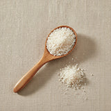 White Copal Resin Powder (Bursera Bipinnata) | Create a luxurious, photorealistic product photograph featuring the original product naturally arranged in an elegant handcrafted wooden spoon on a soft, finely