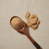 White Oak Bark Powder (Quercus Alba) | Create a luxurious, photorealistic product photograph featuring the original product naturally arranged in an elegant handcrafted wooden spoon on a soft, finely