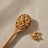 Wintersweet Flower Whole (Chimonanthus Praecox) | Create a luxurious, photorealistic product photograph featuring the original product naturally arranged in an elegant handcrafted wooden spoon on a soft, finely