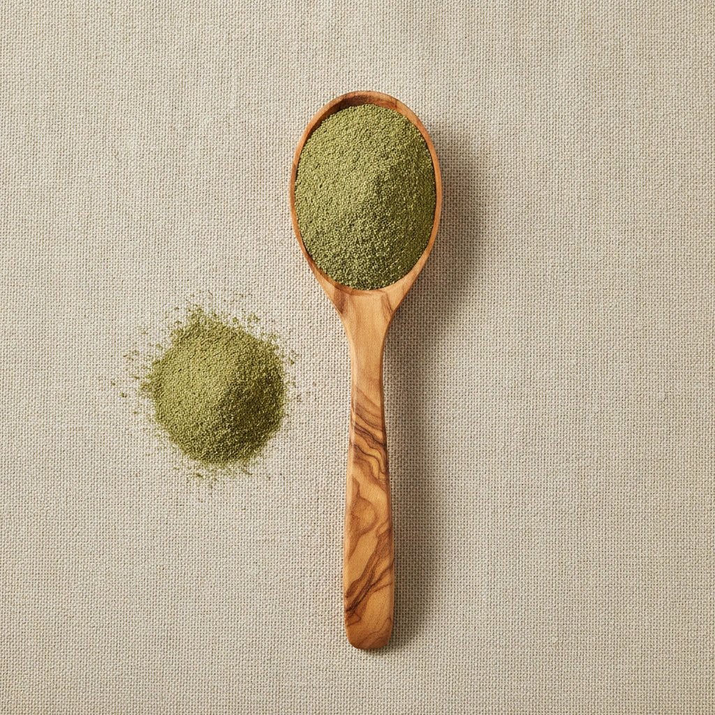 Wormwood Herb Powder (Artemisia Absinthium) | Create a luxurious, photorealistic product photograph featuring the original product naturally arranged in an elegant handcrafted wooden spoon on a soft, finely