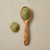 Wormwood Herb Powder (Artemisia Absinthium) | Create a luxurious, photorealistic product photograph featuring the original product naturally arranged in an elegant handcrafted wooden spoon on a soft, finely