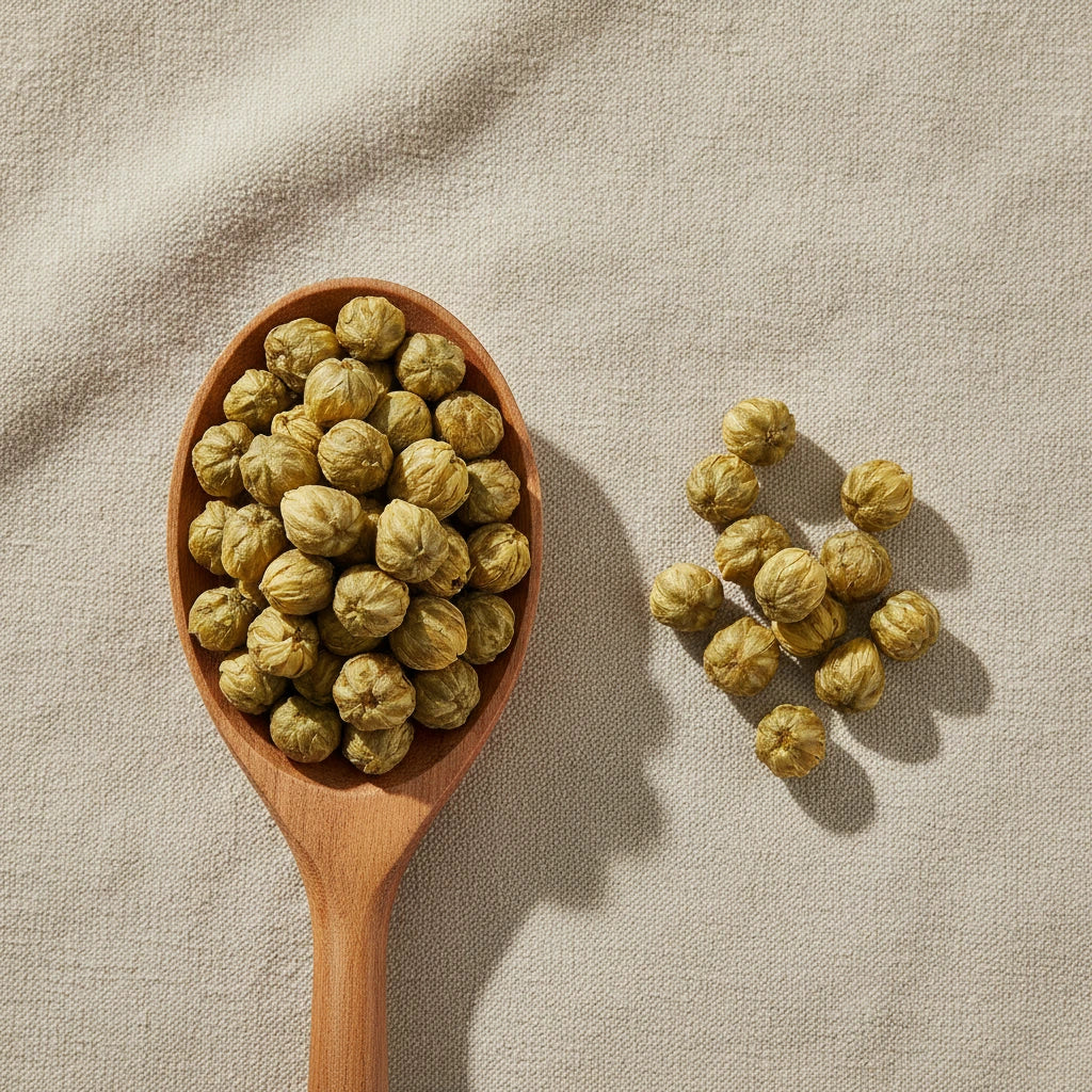 Yellow Chrysanthemum Flower Buds Whole (Chrysanthemum Morifolium) | Create a luxurious, photorealistic product photograph featuring the original product naturally arranged in an elegant handcrafted wooden spoon on a soft, finely