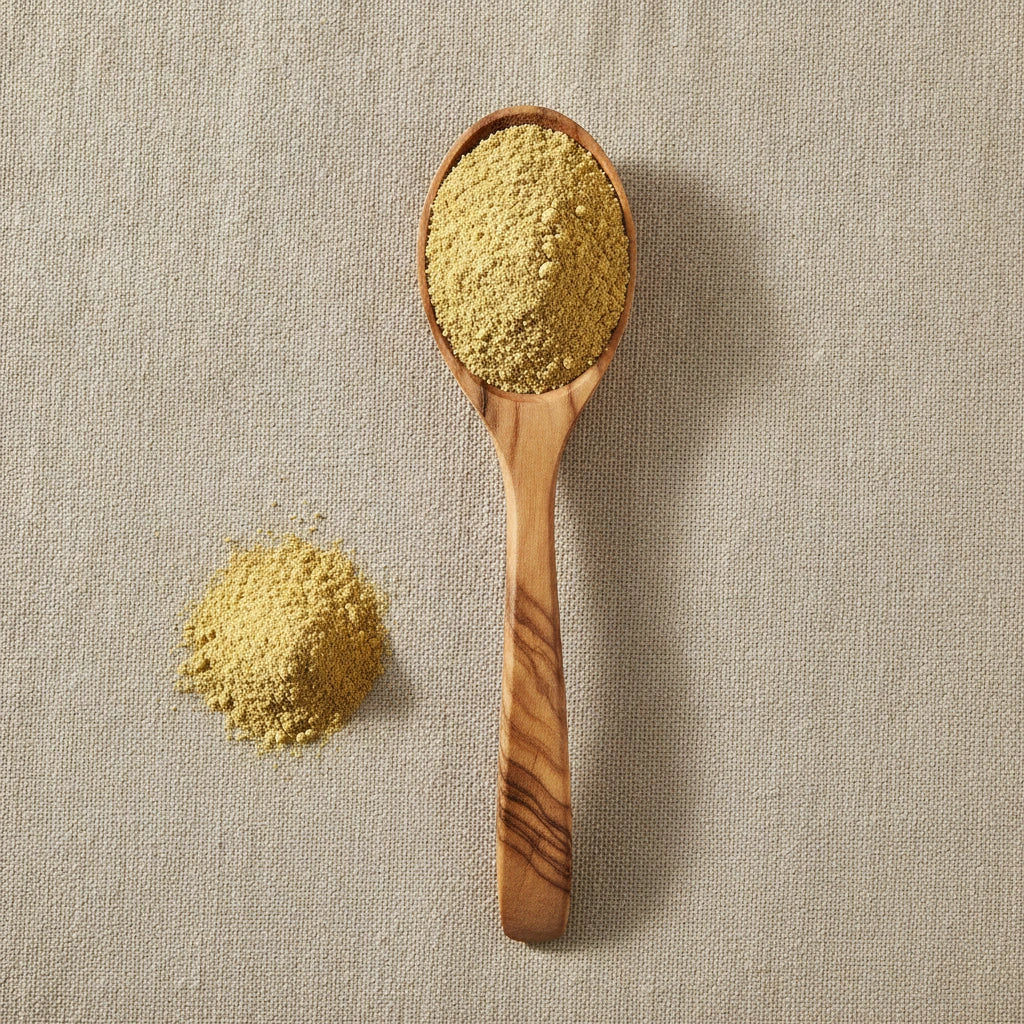Yellow Mustard Seed Powder (Sinapis Alba) | Create a luxurious, photorealistic product photograph featuring the original product naturally arranged in an elegant handcrafted wooden spoon on a soft, finely