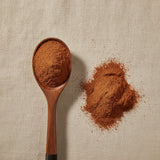Yohimbe Bark Powder (Pausinystalia Yohimbe) | Create a luxurious, photorealistic product photograph featuring the original product naturally arranged in an elegant handcrafted wooden spoon on a soft, finely